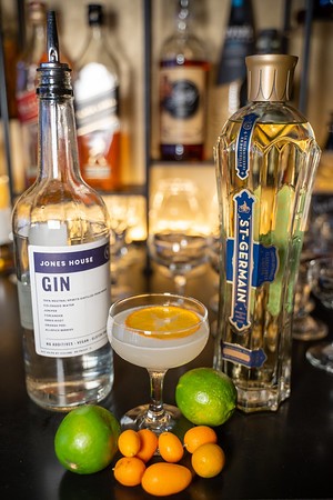 Gin and elderflower cocktail with limes and kumquats