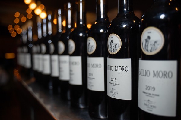 Row of red wine bottles on a back bar